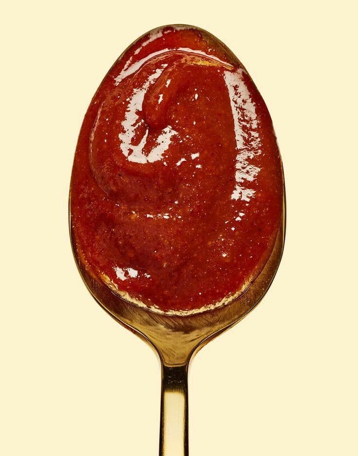 A spoonful of tomato sauce, reduced until it holds its shape